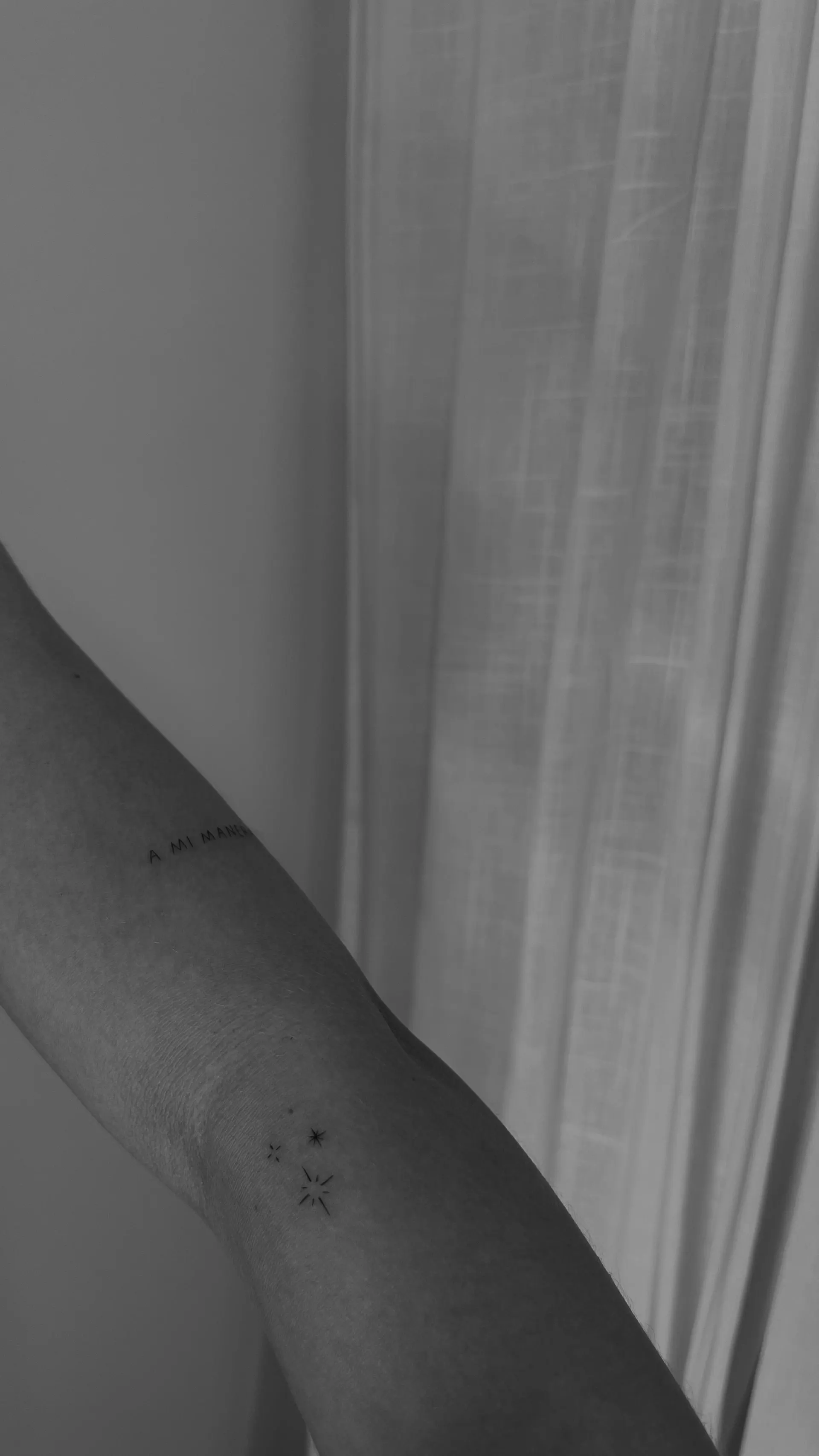 A mi manera lettering with stars on arm