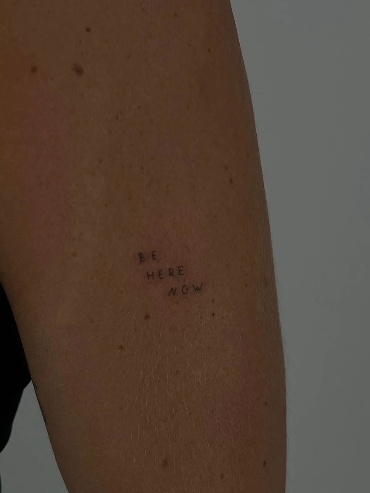 Be Here Now block lettering forearm