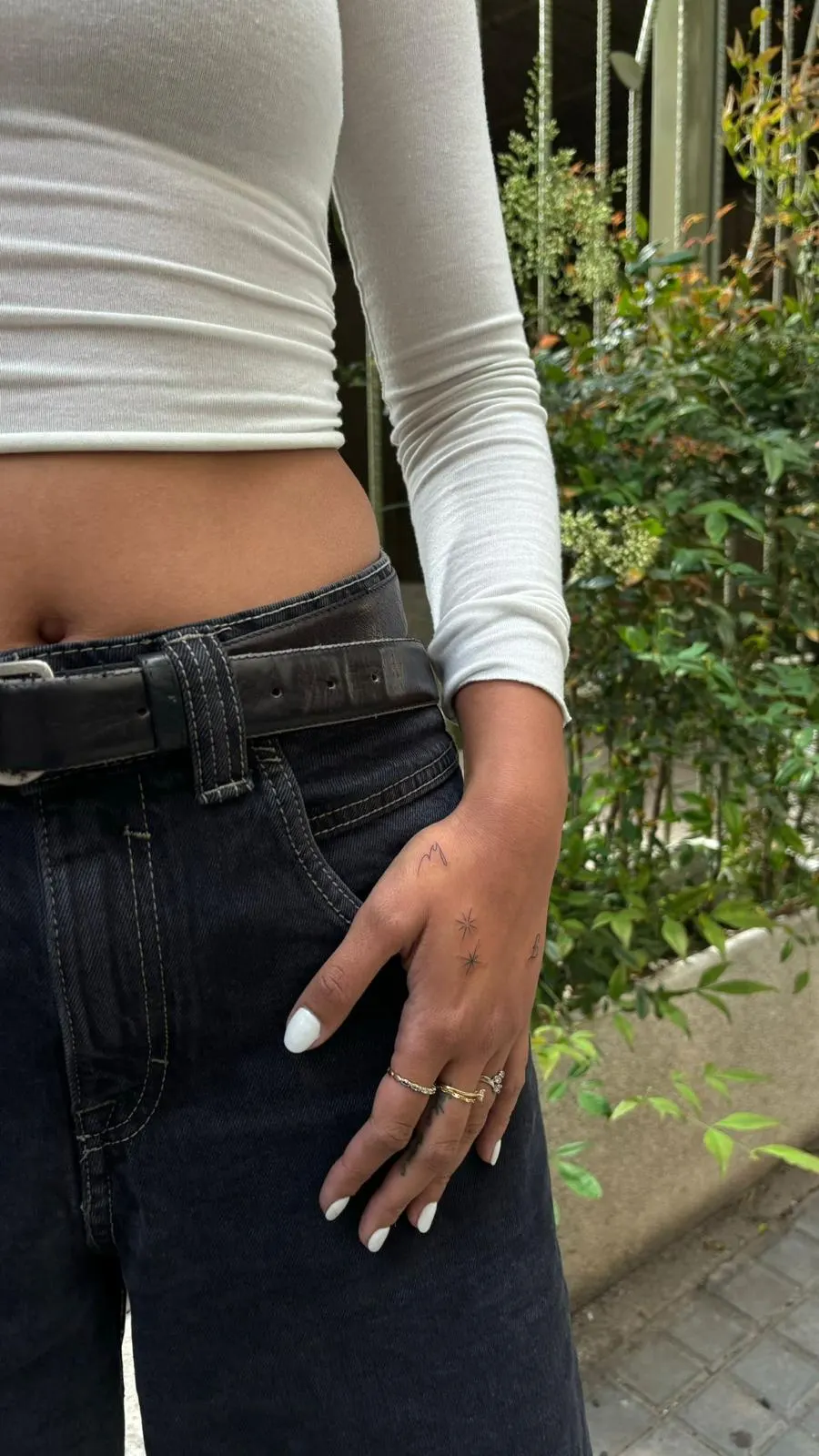 Mini symbol tattoo on hand street style