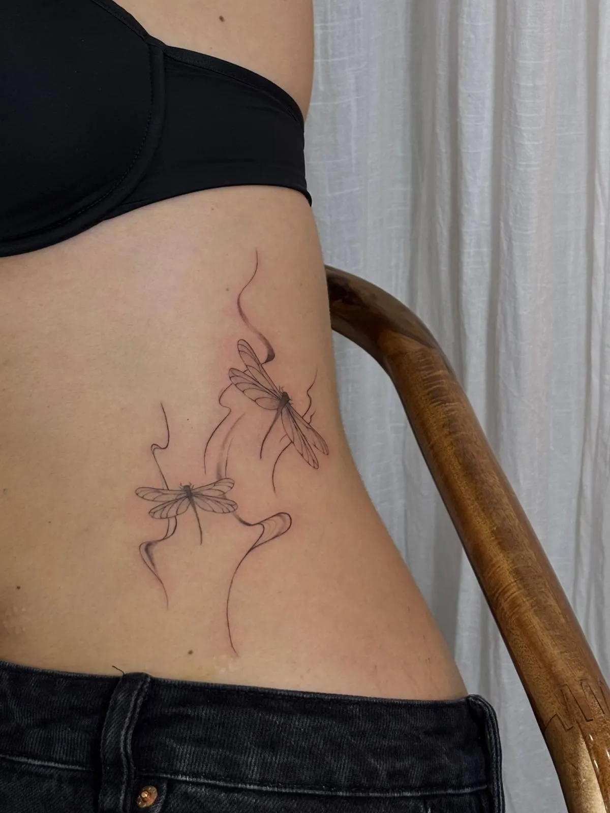 Dragonfly fine line rib tattoo