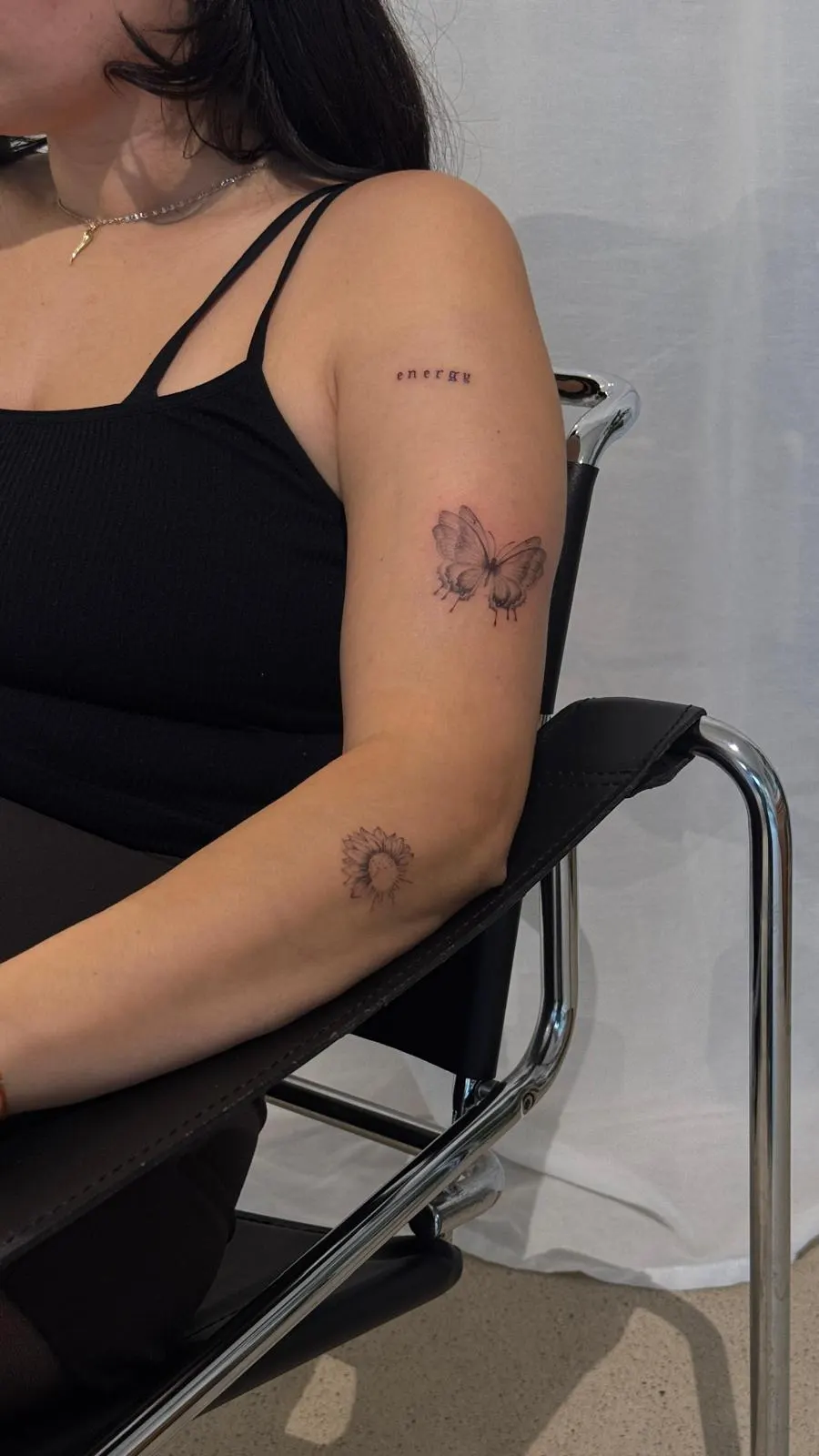 Ornamental butterfly and sunflower tattoo arm